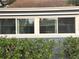 Three-window view with white shutters and lush greenery at 143 44Th N Ave, St Petersburg, FL 33703