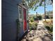 Red front door with sidelights and a wooden walkway at 143 44Th N Ave, St Petersburg, FL 33703