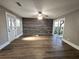 Living room with wood-look floors, ceiling fan and sliding doors to patio at 143 44Th N Ave, St Petersburg, FL 33703