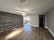 Bright living room featuring wood-look floors and a rustic accent wall at 143 44Th N Ave, St Petersburg, FL 33703