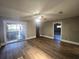 Living room with wood-look floors, ceiling fan and sliding doors to patio at 143 44Th N Ave, St Petersburg, FL 33703