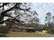 House exterior with a large lot and mature trees at 1505 E Park Cir, Tampa, FL 33610