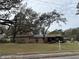 House exterior with a large lot and mature trees at 1505 E Park Cir, Tampa, FL 33610
