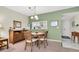 Dining room with round table, chairs, and view to kitchen at 19029 Us Highway 19 N # 5-1, Clearwater, FL 33764