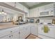 White kitchen features ample counter space and appliances at 19029 Us Highway 19 N # 5-1, Clearwater, FL 33764