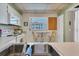 Kitchen with white cabinets, stove and small breakfast bar at 19029 Us Highway 19 N # 5-1, Clearwater, FL 33764