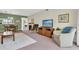 Living room with seating, TV, and view of dining area and fireplace at 19029 Us Highway 19 N # 5-1, Clearwater, FL 33764