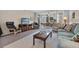 Living room with comfy seating, TV, and access to patio at 19029 Us Highway 19 N # 5-1, Clearwater, FL 33764
