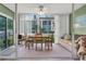 Bright sunroom features a table, chairs, and sofa, perfect for relaxing at 19029 Us Highway 19 N # 5-1, Clearwater, FL 33764