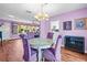 Bright dining room with a round table and four purple chairs at 1918 Virginia Dr, Bradenton, FL 34205