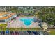 Aerial view of community pool with surrounding lounge chairs and parking at 2460 Canadian Way # 6, Clearwater, FL 33763