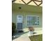 Light green exterior with a front door, window, and potted plant at 2460 Canadian Way # 6, Clearwater, FL 33763