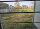 View of grassy backyard area from window, with trees and buildings in the distance at 2850 Somerset Park Dr # 102, Tampa, FL 33613