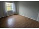 Bedroom with wood-look flooring and window with curtains at 2850 Somerset Park Dr # 102, Tampa, FL 33613