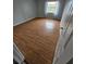Bedroom with wood-look flooring and window with curtains at 2850 Somerset Park Dr # 102, Tampa, FL 33613