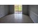 Spacious living room featuring tile flooring and sliding glass doors at 2850 Somerset Park Dr # 102, Tampa, FL 33613