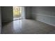 Spacious living room featuring tile flooring and sliding glass doors at 2850 Somerset Park Dr # 102, Tampa, FL 33613