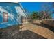 A large fenced back yard including a screened in patio area, and view of the exterior of the home at 5524 Kentucky Ave, New Port Richey, FL 34652