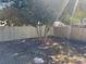 Fenced backyard with a small tree at 5524 Kentucky Ave, New Port Richey, FL 34652