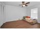 Bedroom featuring wood laminate flooring, ceiling fan and a closet at 5524 Kentucky Ave, New Port Richey, FL 34652