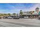 Street level view of a commercial area with a variety of restaurants, shops, sidewalks and palm trees at 5524 Kentucky Ave, New Port Richey, FL 34652