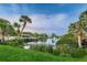 Beautiful community lake with a fountain, dock, and lush tropical landscaping at 5524 Kentucky Ave, New Port Richey, FL 34652