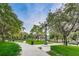 Community park featuring sidewalks, mature shade trees, and benches for residents at 5524 Kentucky Ave, New Port Richey, FL 34652
