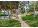 Sidewalk winds through a lush green park, offering waterside views and shady trees at 5524 Kentucky Ave, New Port Richey, FL 34652
