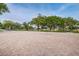 Open community event space with a brick surface bordered by green lawns and mature oak trees at 5524 Kentucky Ave, New Port Richey, FL 34652