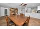 Dining area with ceiling fan, tile floor, and wood accent wall at 5524 Kentucky Ave, New Port Richey, FL 34652