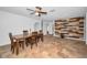 Dining room with tiled floor, ceiling fan, and decorative wood accent wall at 5524 Kentucky Ave, New Port Richey, FL 34652