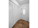 Bright foyer featuring closet storage and a decorative front door, with neutral tile flooring at 5524 Kentucky Ave, New Port Richey, FL 34652