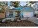 Charming blue single-Gathering home with a well-maintained lawn and a one-car garage at 5524 Kentucky Ave, New Port Richey, FL 34652