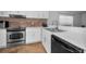 Modern kitchen with white cabinets, stainless steel appliances, and tile floors at 5524 Kentucky Ave, New Port Richey, FL 34652