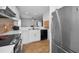 Kitchen featuring white cabinets, stainless steel appliances, and tile backsplash at 5524 Kentucky Ave, New Port Richey, FL 34652