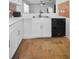 Bright kitchen with modern white cabinetry, contrasting black appliances, and patterned tile flooring at 5524 Kentucky Ave, New Port Richey, FL 34652