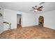 Spacious living room with tile flooring, ceiling fan, and unique arched doorway at 5524 Kentucky Ave, New Port Richey, FL 34652