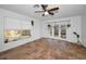 Well-lit living area featuring tile floors, neutral walls, french doors and a ceiling fan at 5524 Kentucky Ave, New Port Richey, FL 34652