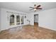 Bright living room featuring tile floors, ceiling fan, and French doors to the backyard at 5524 Kentucky Ave, New Port Richey, FL 34652