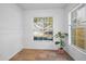 Bright living space featuring tile floors, neutral paint, and a large window with lovely backyard view at 5524 Kentucky Ave, New Port Richey, FL 34652