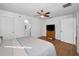 Spacious main bedroom with laminate flooring, a ceiling fan, and an ensuite bathroom at 5524 Kentucky Ave, New Port Richey, FL 34652