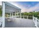 Community pier pavilion with benches and a lake view surrounded by trees and green space at 5524 Kentucky Ave, New Port Richey, FL 34652