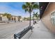 Street view in a commercial area with palm trees, street lamps, benches and sidewalks lined with buildings at 5524 Kentucky Ave, New Port Richey, FL 34652