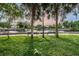 Scenic waterfront park with benches, trees, grassy area, and a glimpse of waterfront homes in the background at 5524 Kentucky Ave, New Port Richey, FL 34652