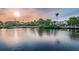 Waterfront property with beautiful sunset view, dock and lush tropical landscaping, and a single Gathering home at 5524 Kentucky Ave, New Port Richey, FL 34652