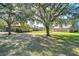 Property features main house, detached garage, and large yard at 8345 Shenandoah Run, Wesley Chapel, FL 33544
