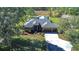 One-story home with three-car garage, screened pool, and landscaped yard at 8345 Shenandoah Run, Wesley Chapel, FL 33544
