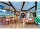 Rustic wet bar with wooden stools and glass shelving at 8345 Shenandoah Run, Wesley Chapel, FL 33544