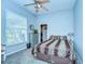 Serene bedroom with light blue walls, carpeted floors, and a comfortable bed at 8345 Shenandoah Run, Wesley Chapel, FL 33544