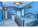 Spacious bedroom with blue walls, carpeted floors, and a metal bed frame at 8345 Shenandoah Run, Wesley Chapel, FL 33544